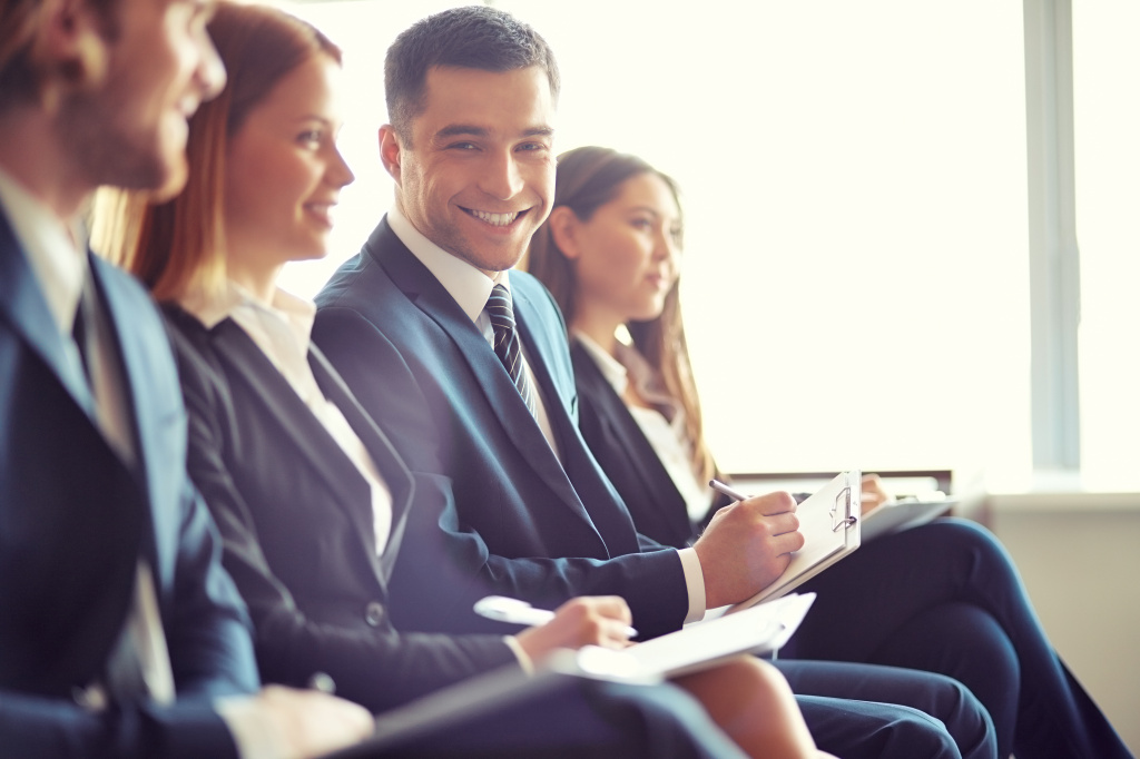 smiling-businessman-in-a-convention.jpg