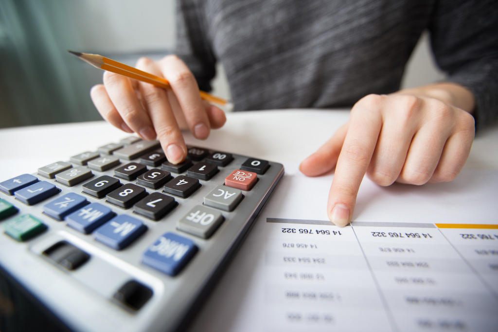 closeup-accountant-hands-counting-calculator.jpg